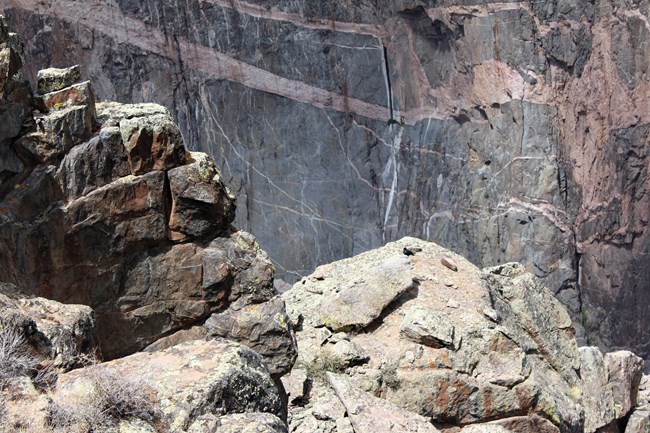 Different layers of rock visible in foreground and background of a canyon