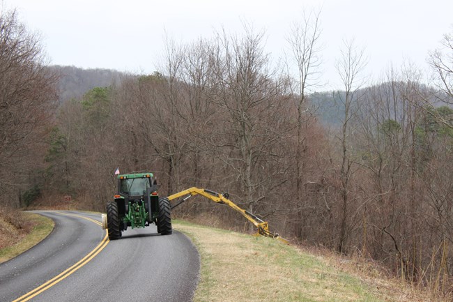 Boomax tractor clearing shrugs alongside Parkway road