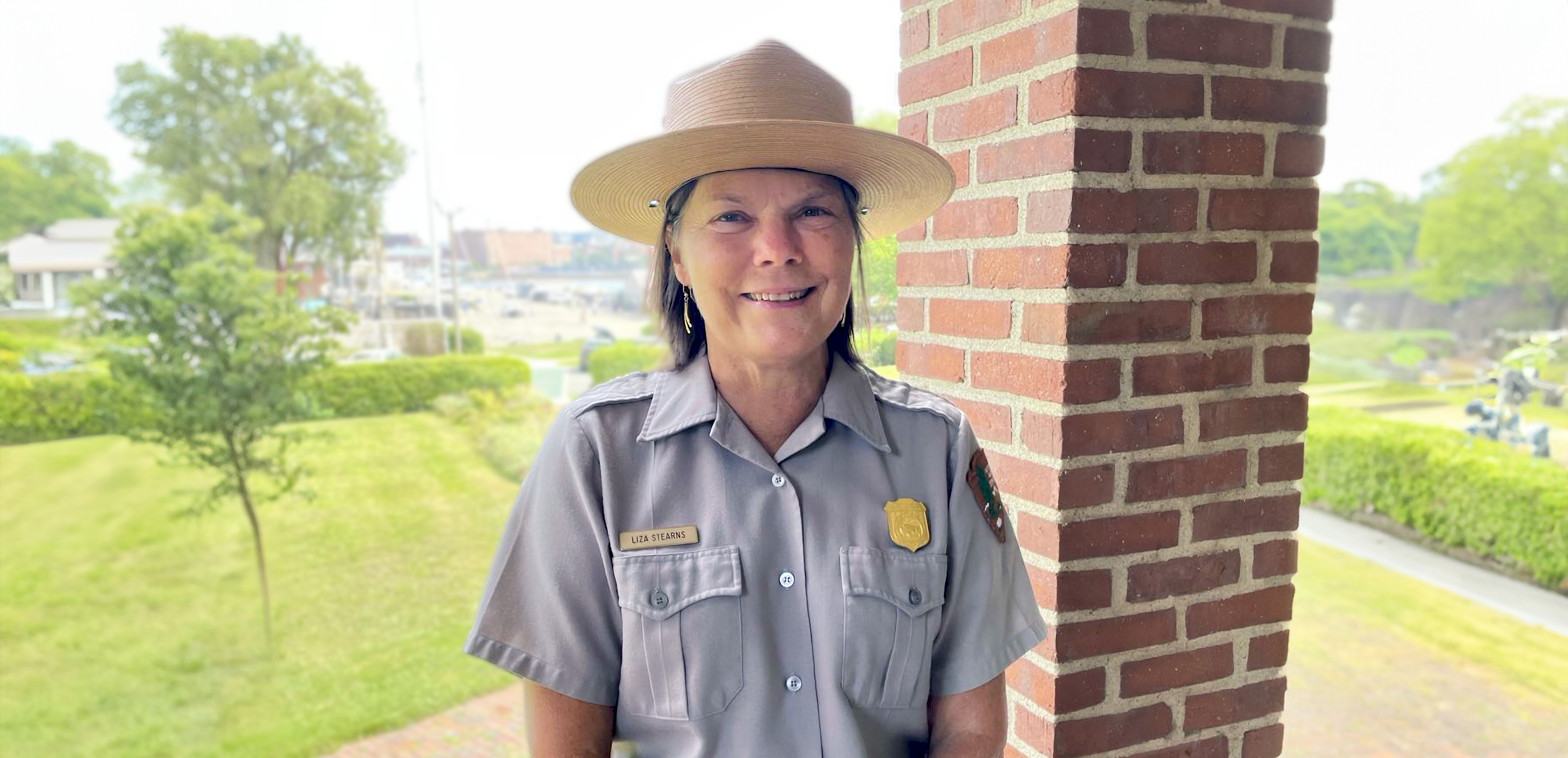 Portrait of Liza Stearns, dressed in NPS uniform with flat hat.