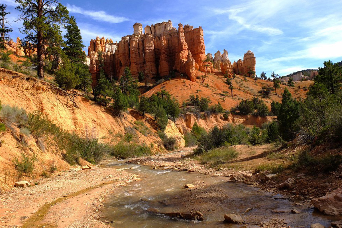 Red rock spires above stream