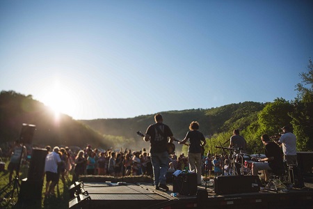 Band members play in the setting sun