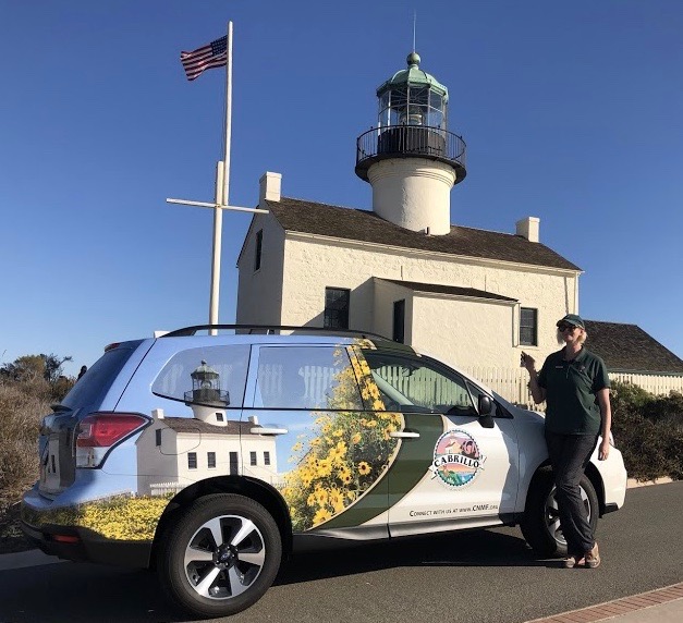 Outreach Coordinator Sam poses by the Cabrillo National Monument Foundation’s outreach vehicle.