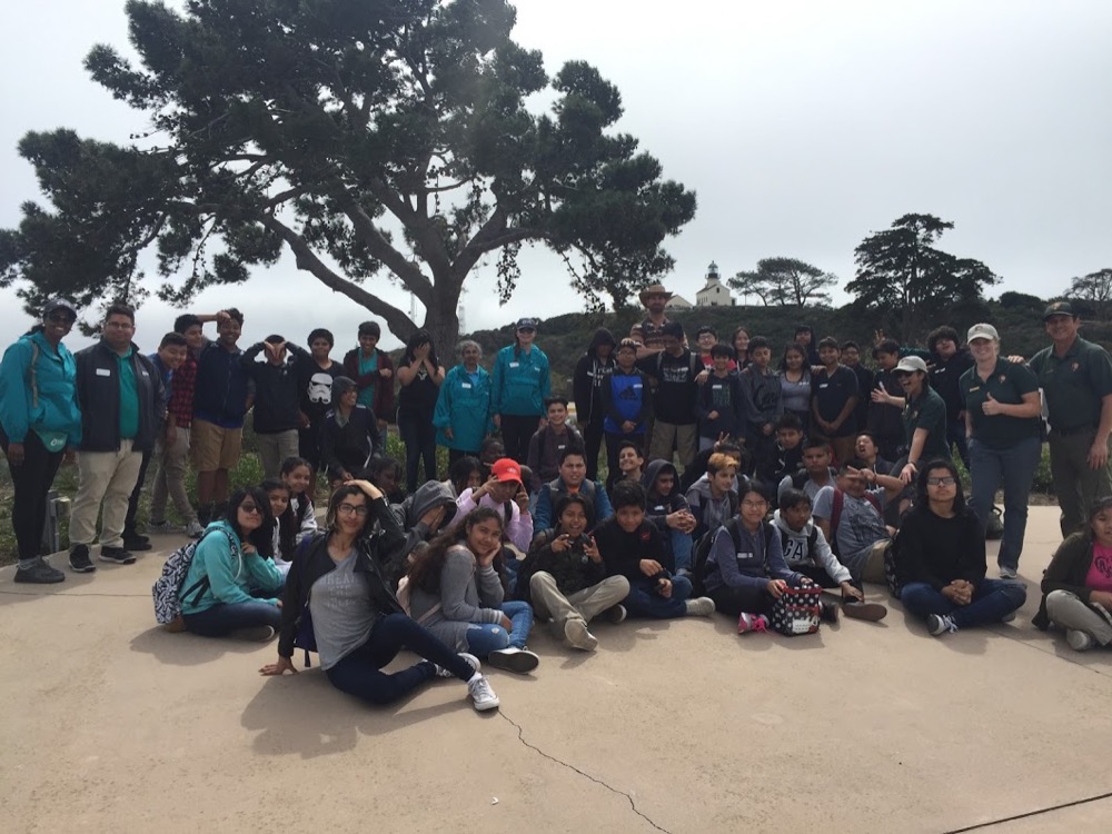 A group of people, including the Cabrillo Science Education team, Ocean Discovery Institute staff, and a 7th grade class at Cabrillo National Monument.