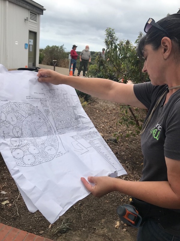 VIP Patricia Simpson reviews the landscape plans for where to put her next plant.