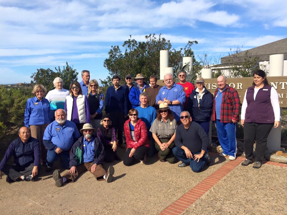a group of people smiling for the camera near the Visitor Center at Cabrillo National Monument.
