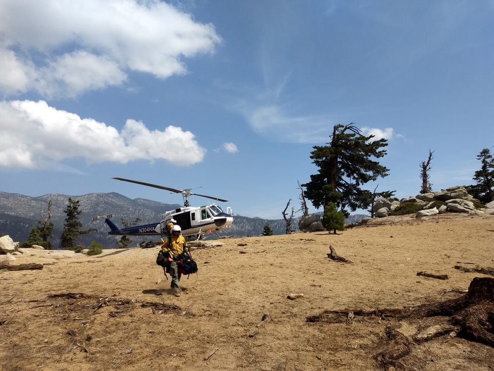 a fire crew gets dropped off by helicopter during the Cranston Fire outside of Idyllwild, CA in July 2018.