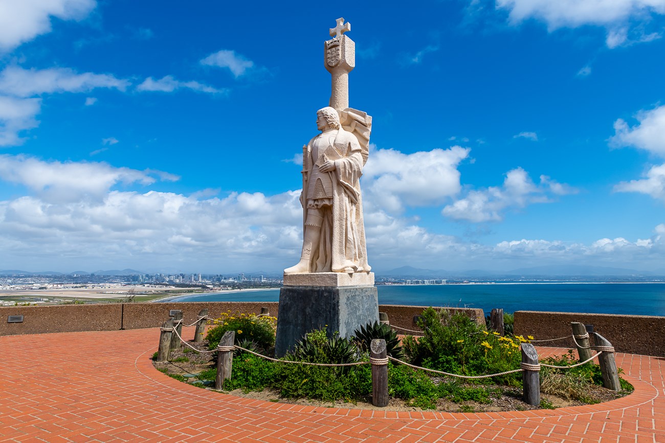 Photo of the Cabrillo monument/statue surrounded by a plaza with a view.