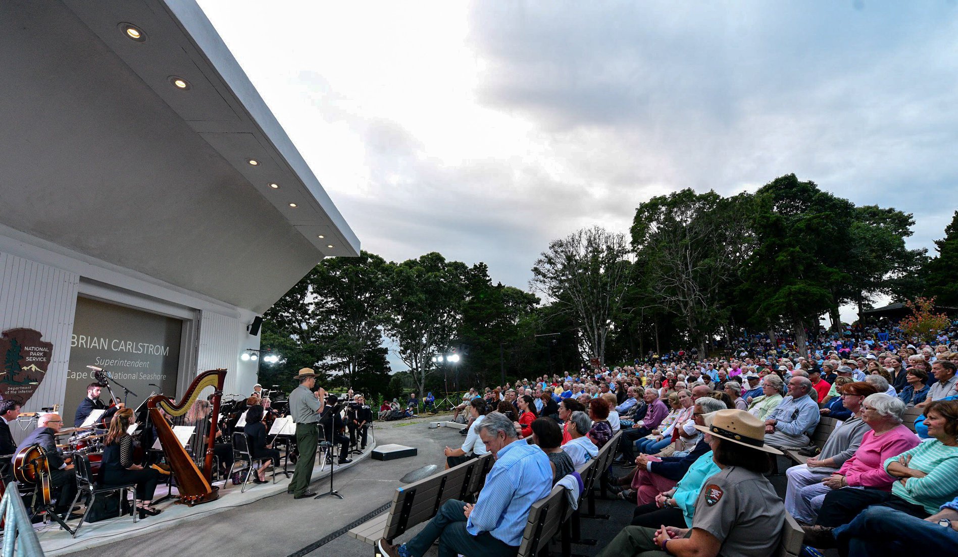 A park ranger addresses a crowd of visitors