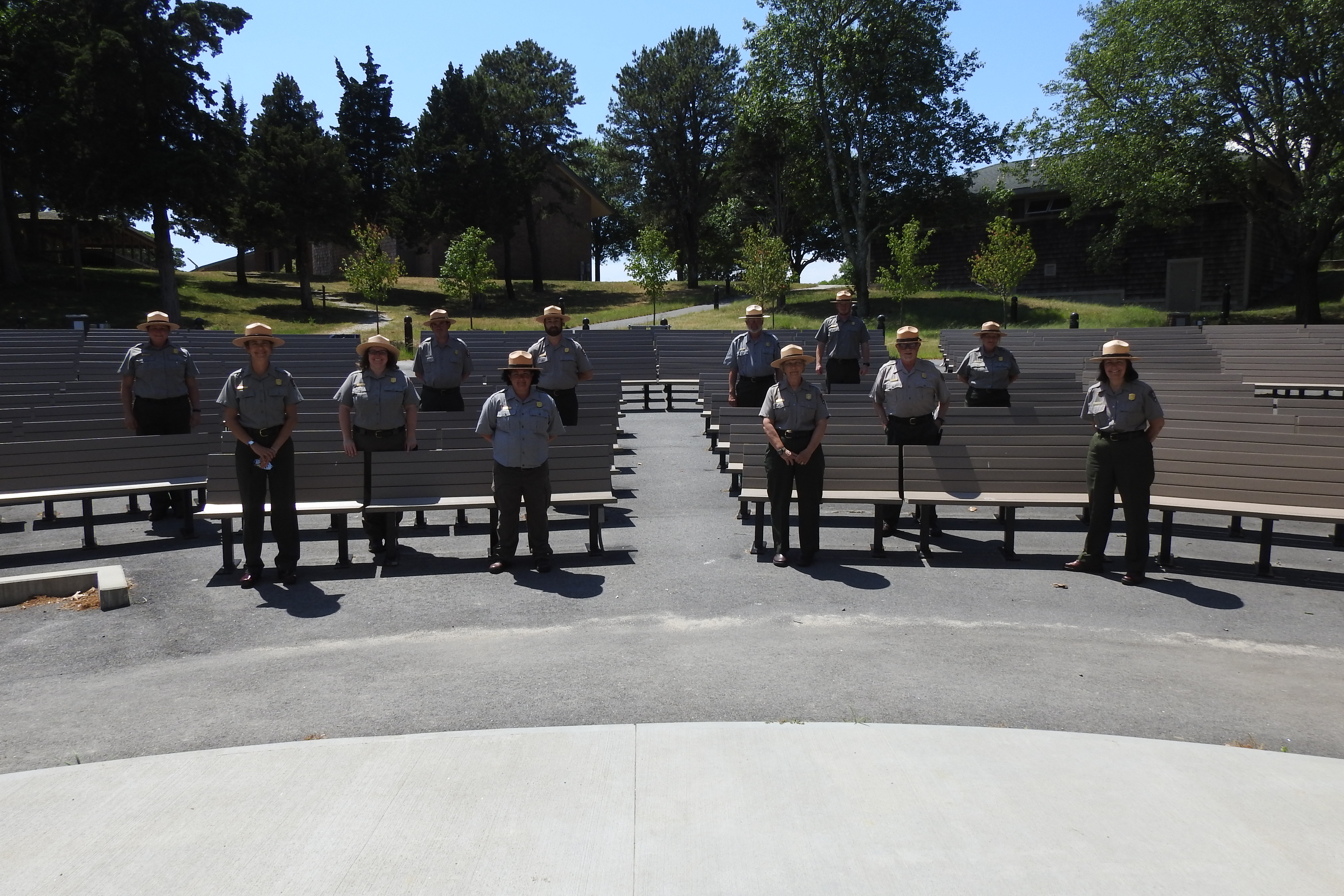 Twelve rangers stand in an outdoor amphitheater