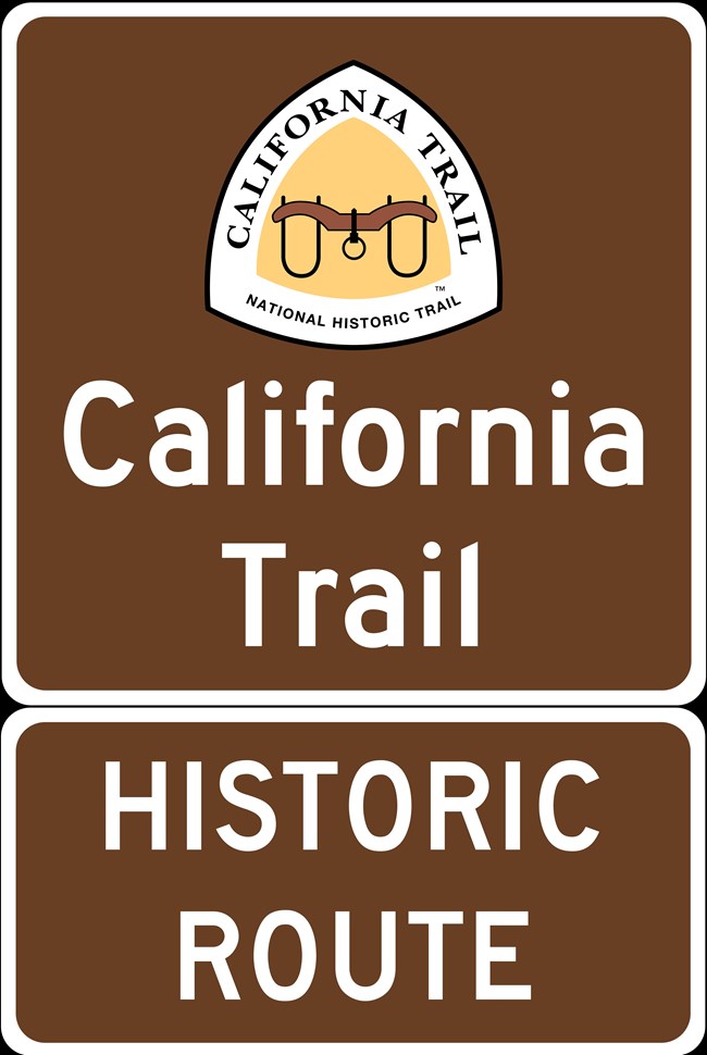 Brown sign with white letters, "California Trail Historic Route," with yellow triangle logo.