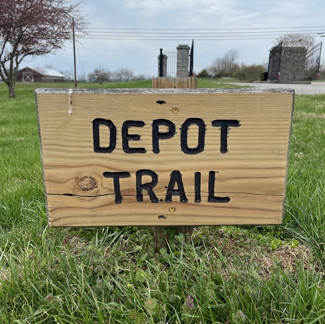 A wooden sign that reads Depot Trail.