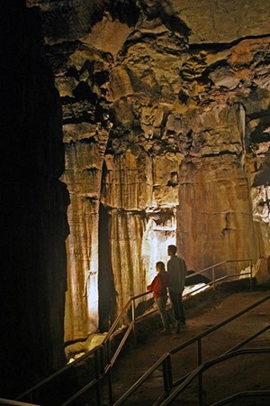 Visitors explore underground caverns.