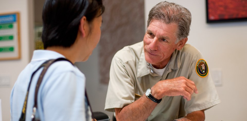 a volunteer speaks to a woman