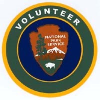 Volunteer logo, green border, dark blue background, and NPS arrowhead in center.