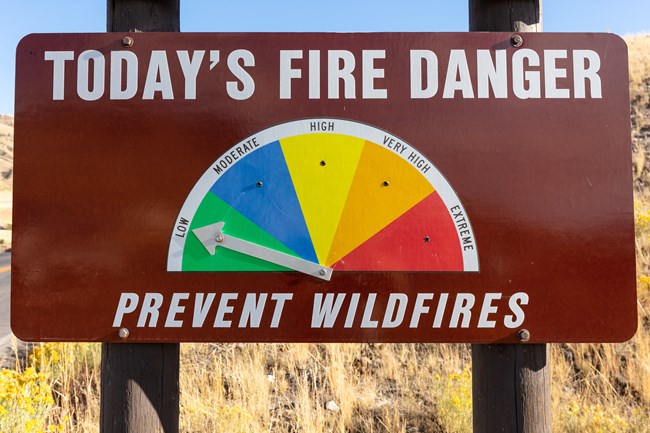 Fire danger sign with arrow pointing to low.