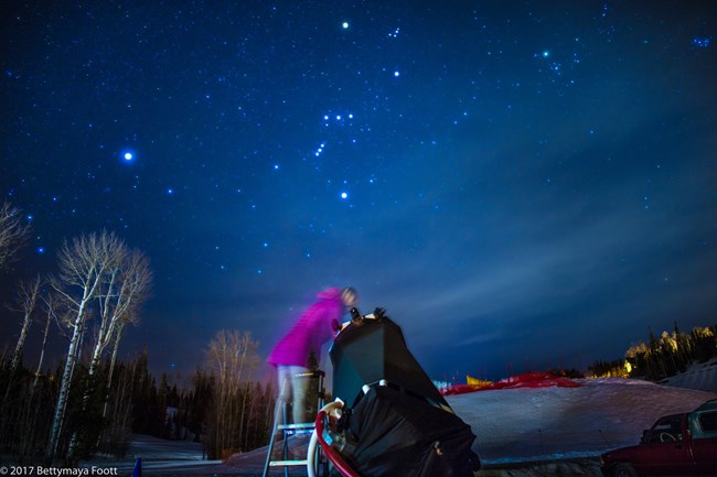 A park visitor peers into a telescope for a closer view of the stars during an astronomy program.