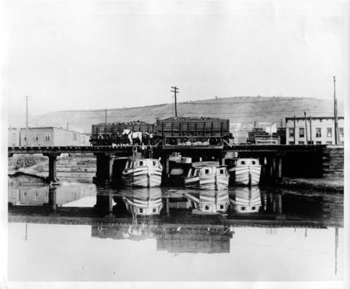 Black & white image of Canal barges waiting to be filled with coal from the mines of Western Maryland, West Virginia, and South Western Pennsylvania.