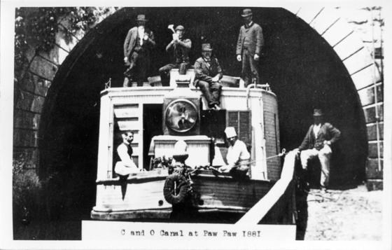 Black & White image of Canal workers on a Canal Boat going through Paw Paw Tunnel.