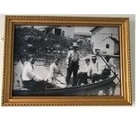 Historical image of persons in canal boat.