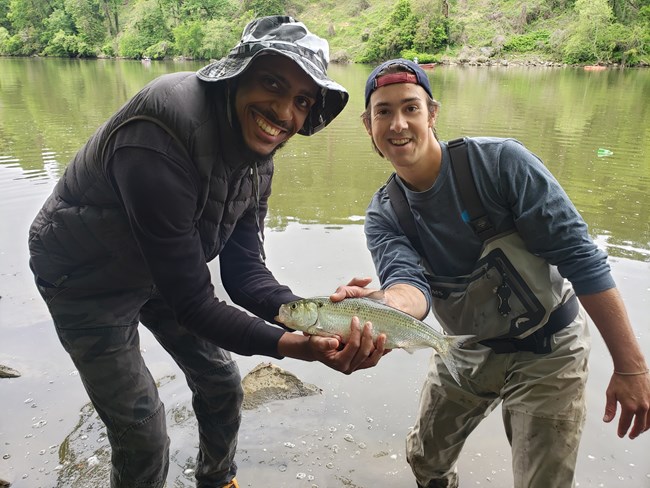 Two men holding a fish