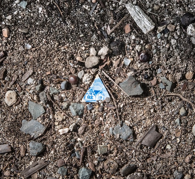 photograph of blue and white china on the ground surface