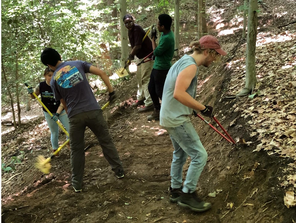 Historical black and white image of CCC members repairing a section of towpath of the C&O Canal.