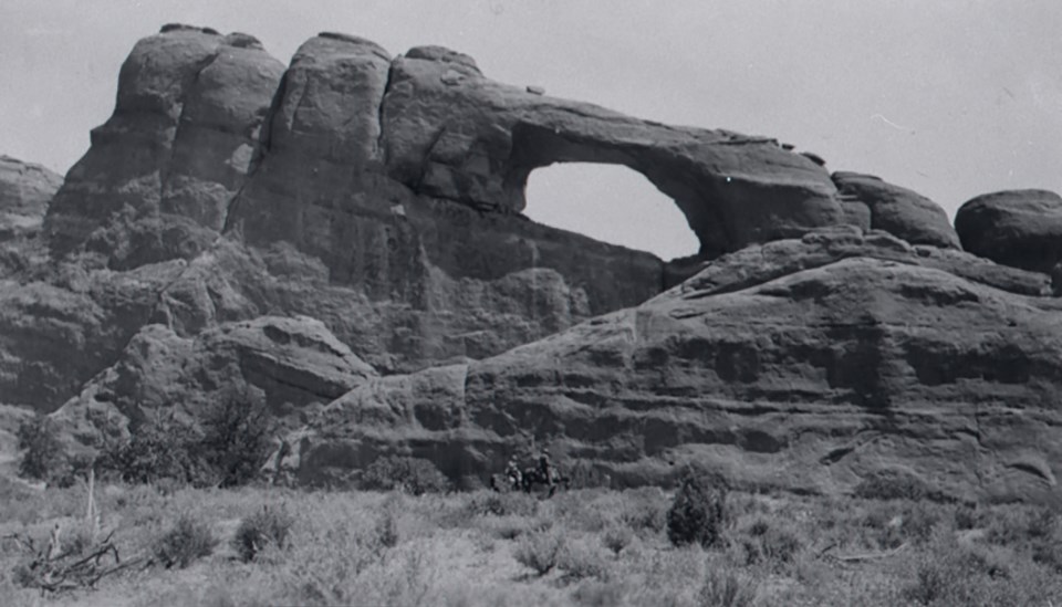 an arch with a large boulder on one side