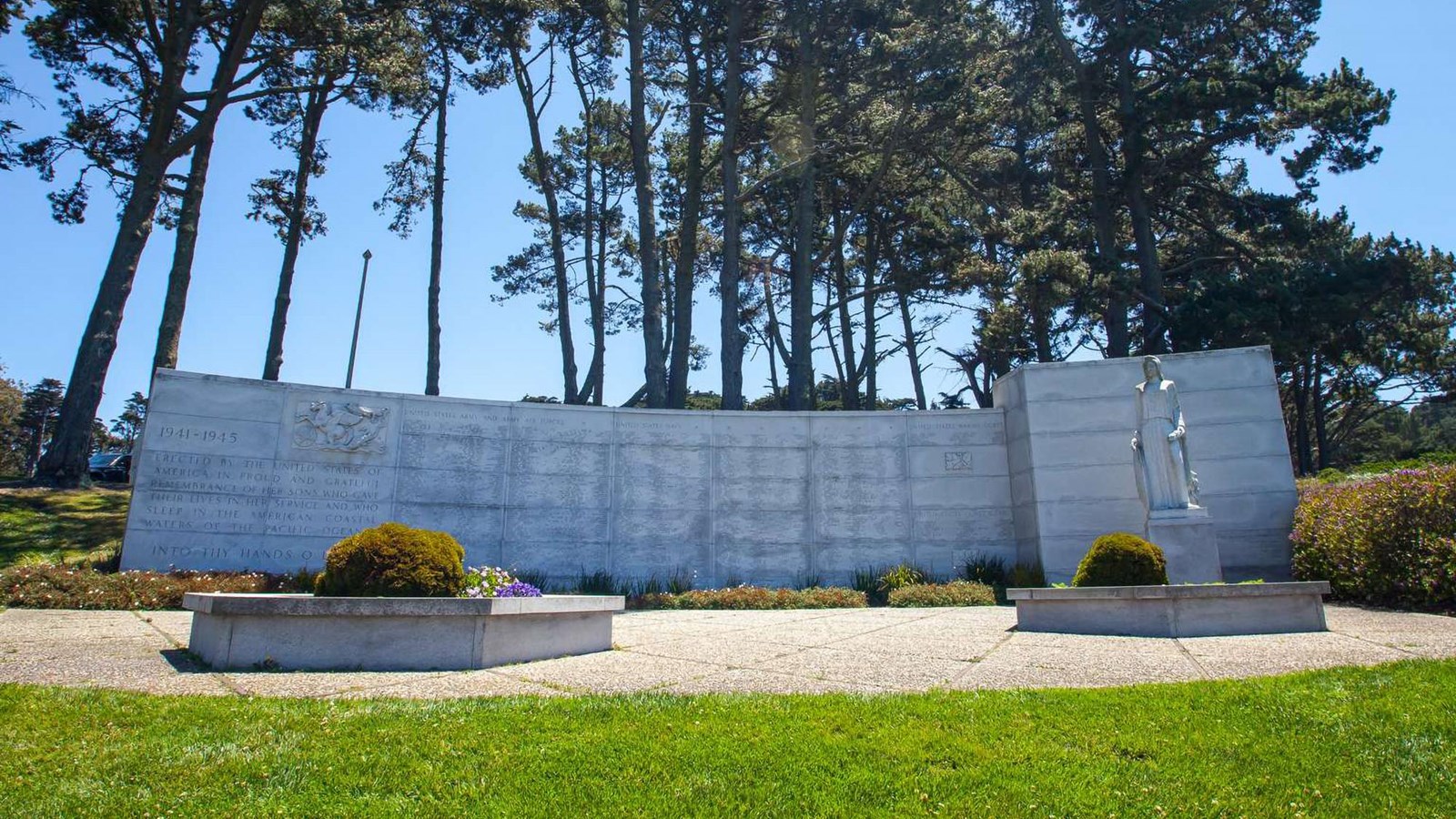 The wide granite span of the memorial wall lists the many names of soldiers killed in action. 