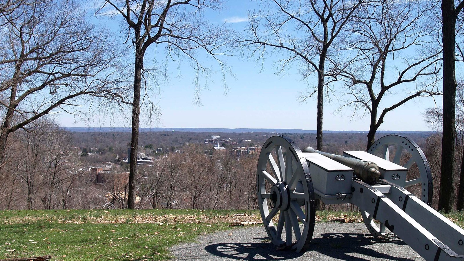 A cannon from the Revolutionary War era overlooks a valley.