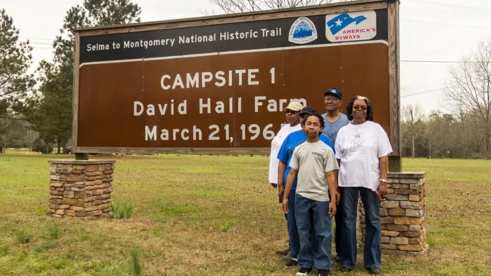 A large brown sign reads, 