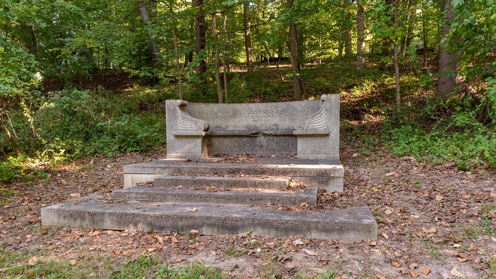 A large stone monument in a wooded area.