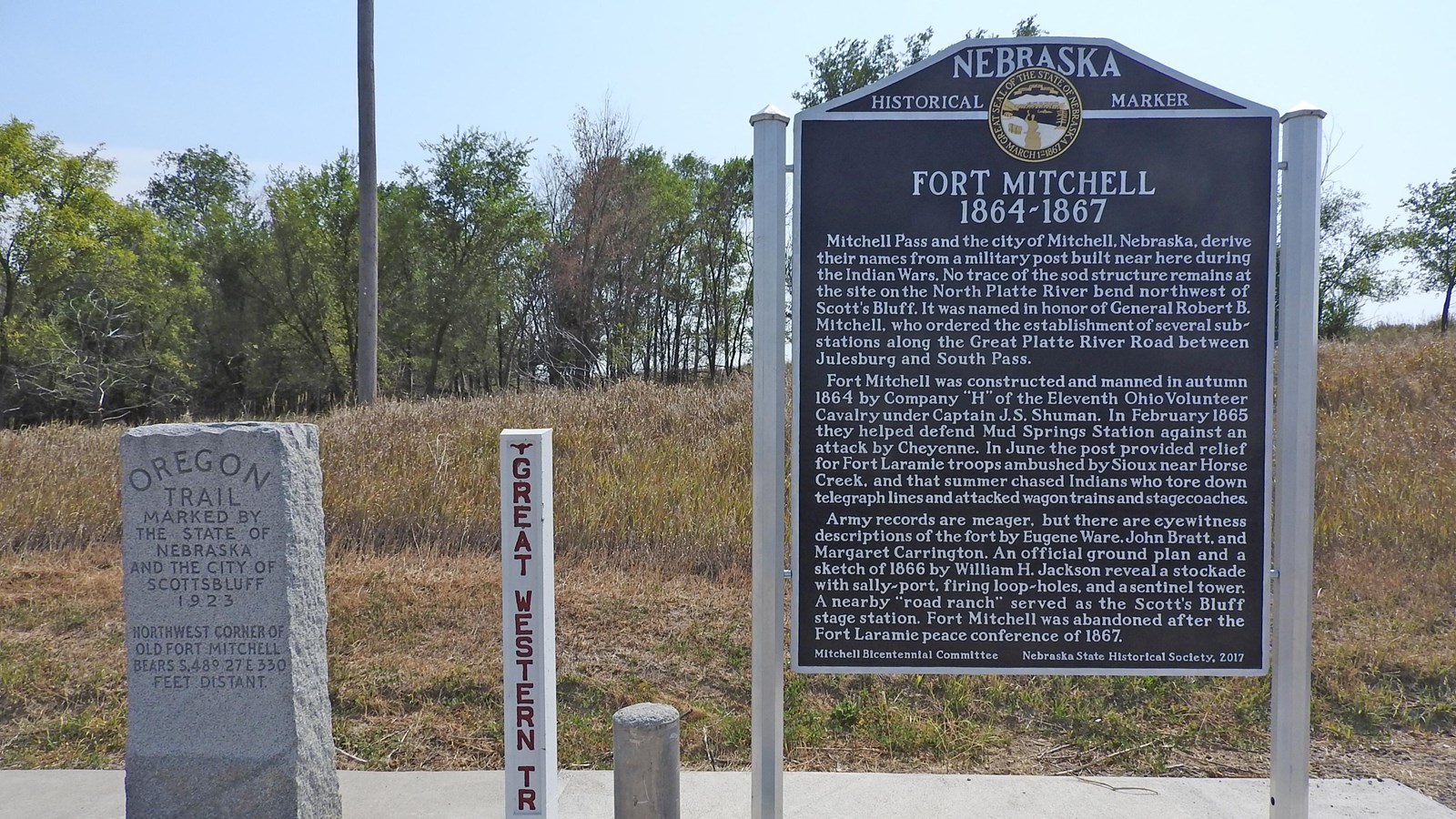 A monument to the Oregon Trail is seen next to a historical sign about Fort Mitchell