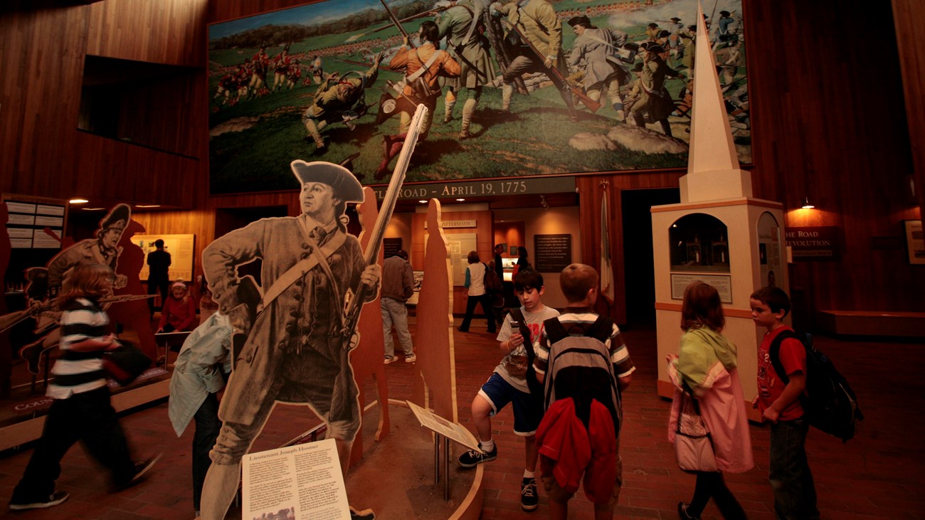 Children in the visitor center lobby exploring Revolutionary War-related exhibits