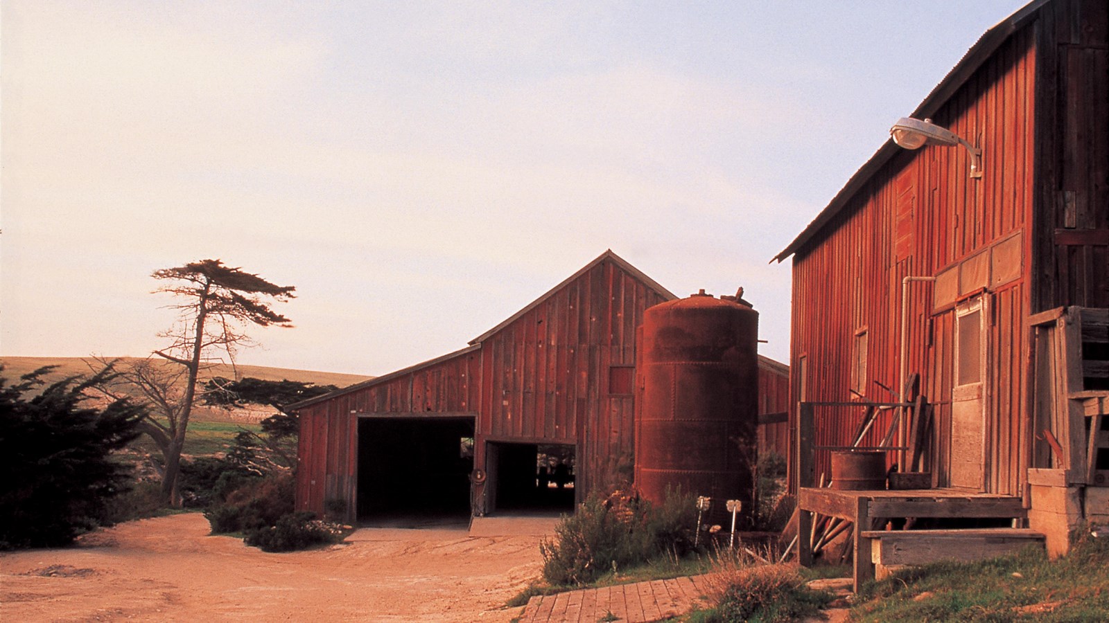 red barns along dirt road