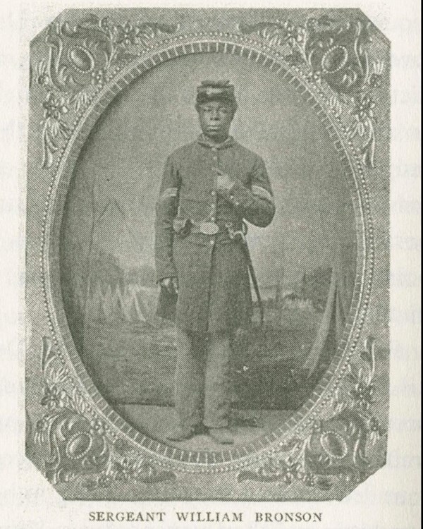 A black and white printed image of an African American Soldier in uniform in the 1860s.