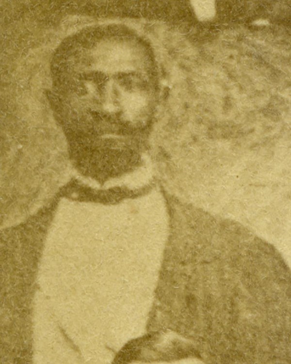 A portrait of an African American man in a suit and bowtie in the 1880s.