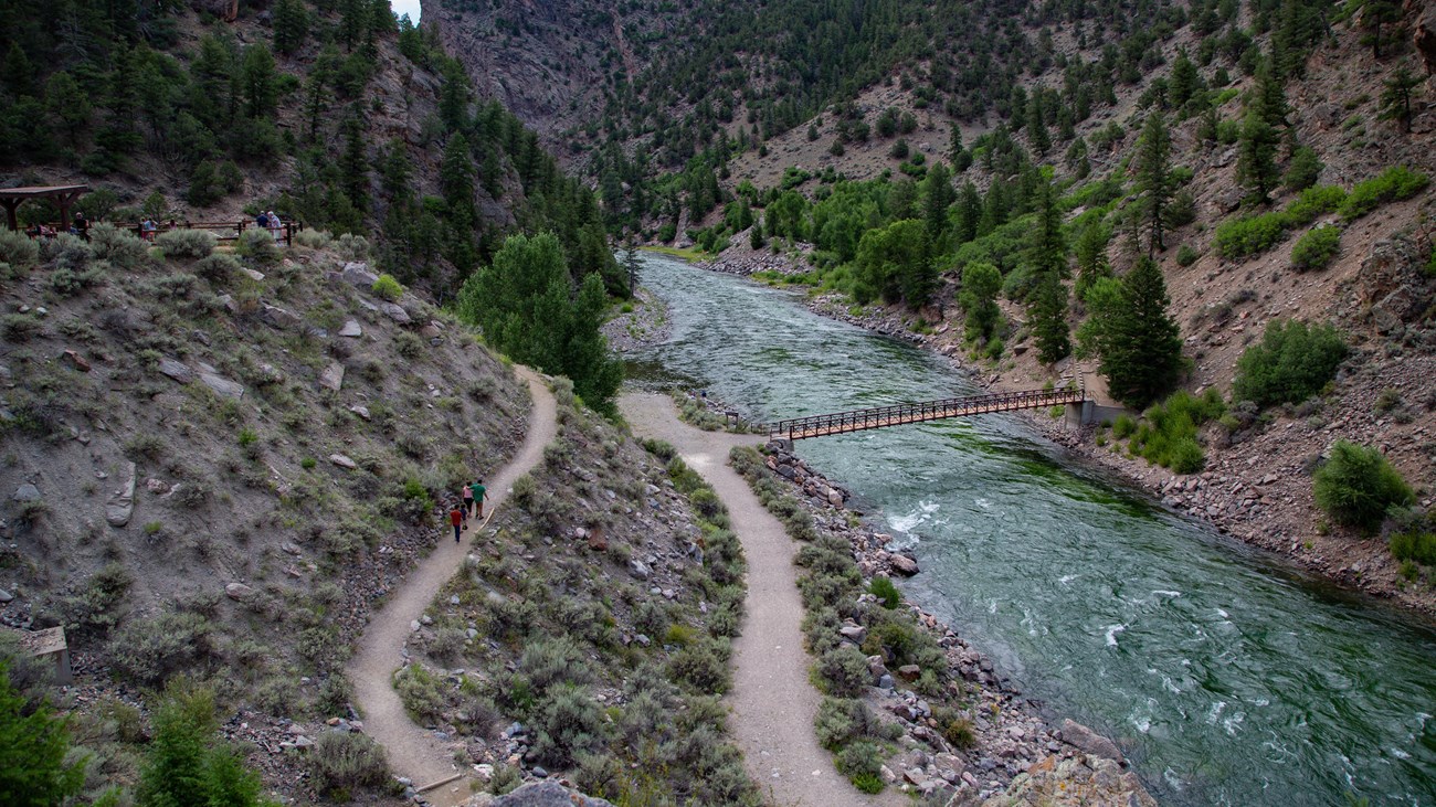 A footpath goes back and forth next to a narrow canyon and river