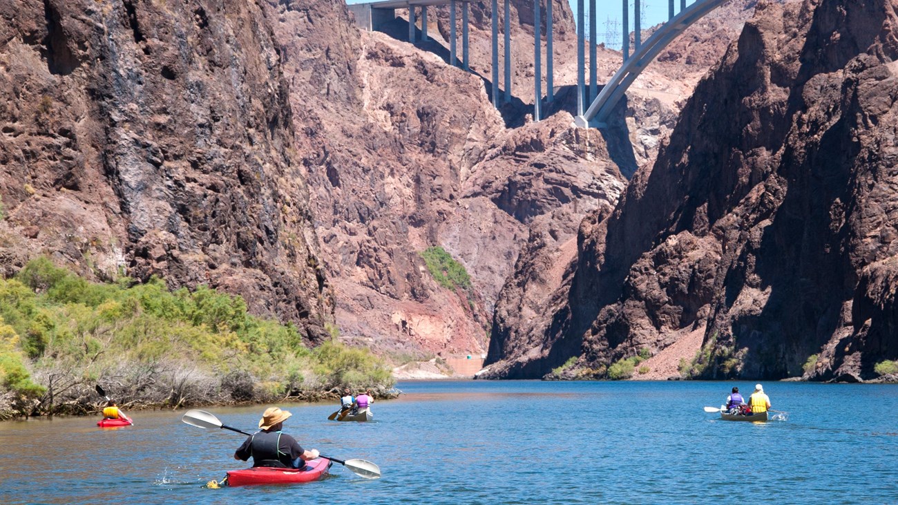 Kayakers on a river in a canyon