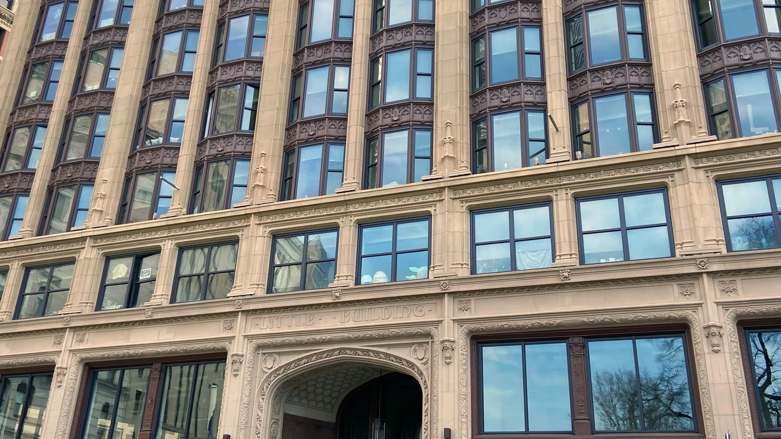 Tall stone building with lots of windows