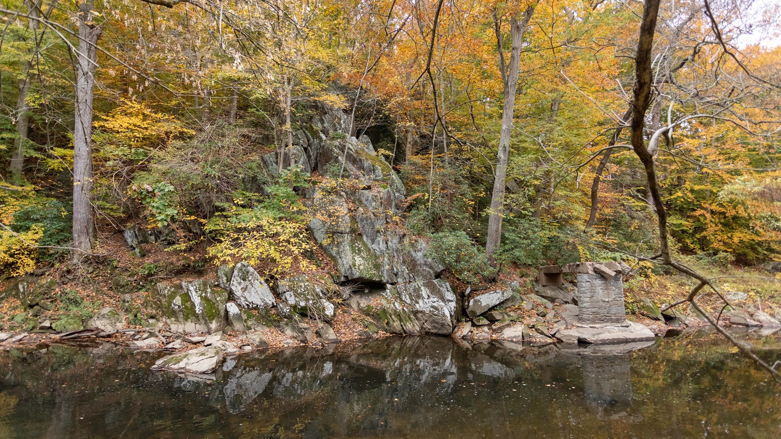 A rocky embankment next to a river. 