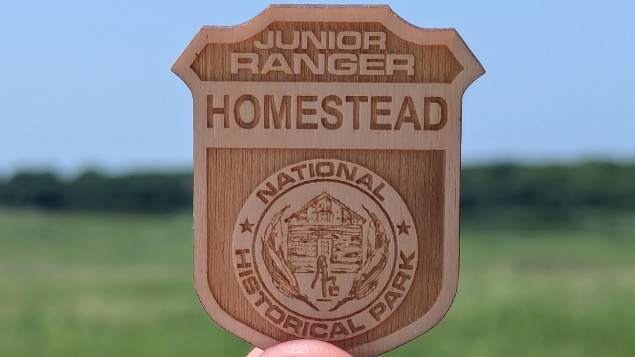 Wooden badge reading 