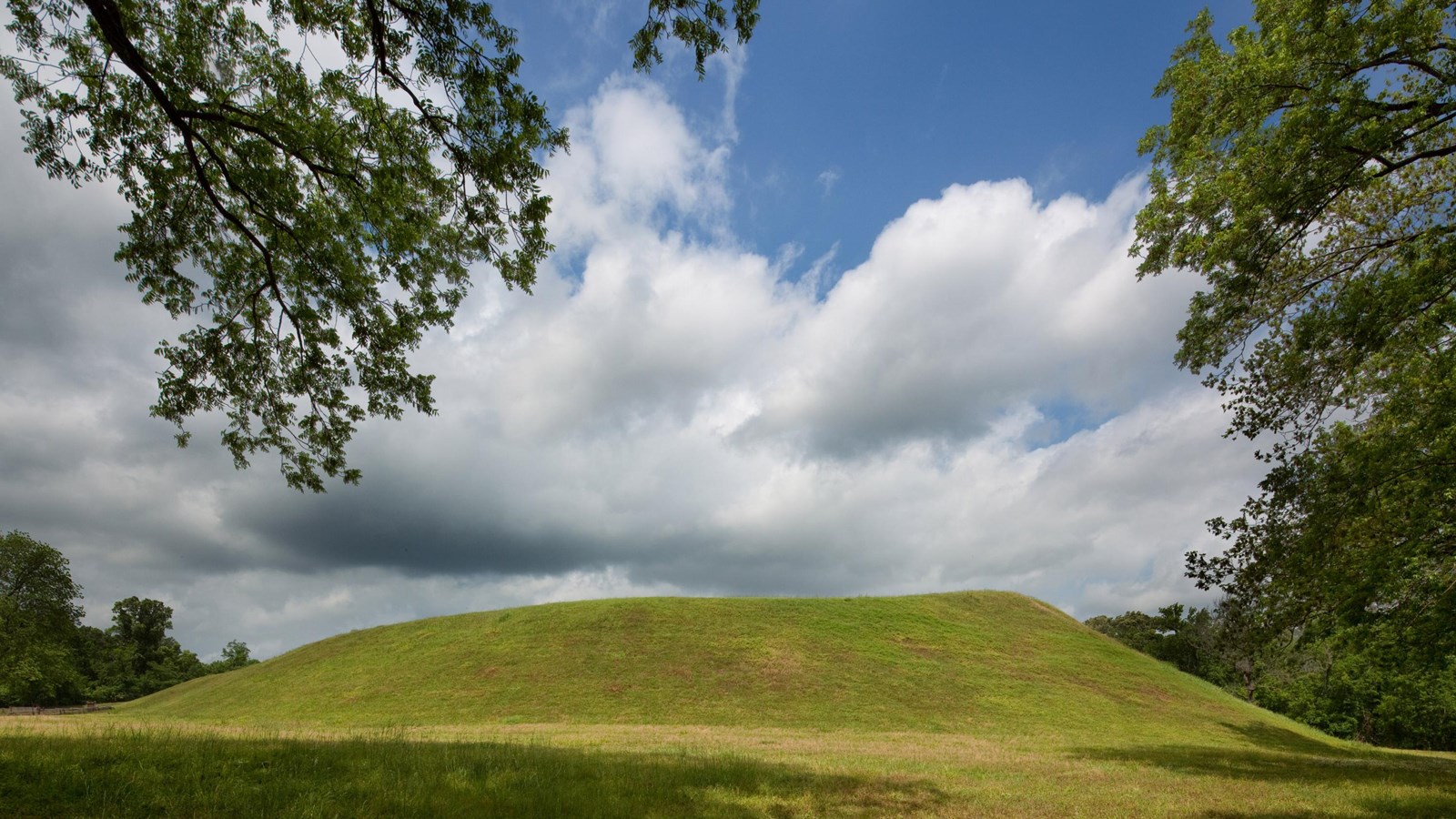 A large grass covered flat top American Indian Mound