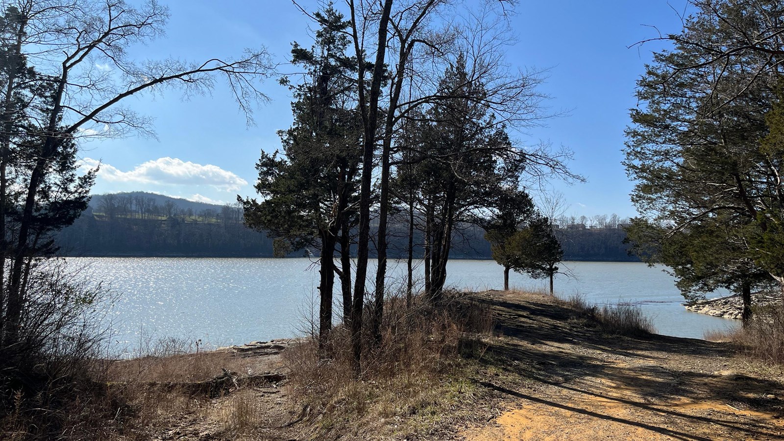 A gravel road leading down to a body of water that is Lake Cumberland.
