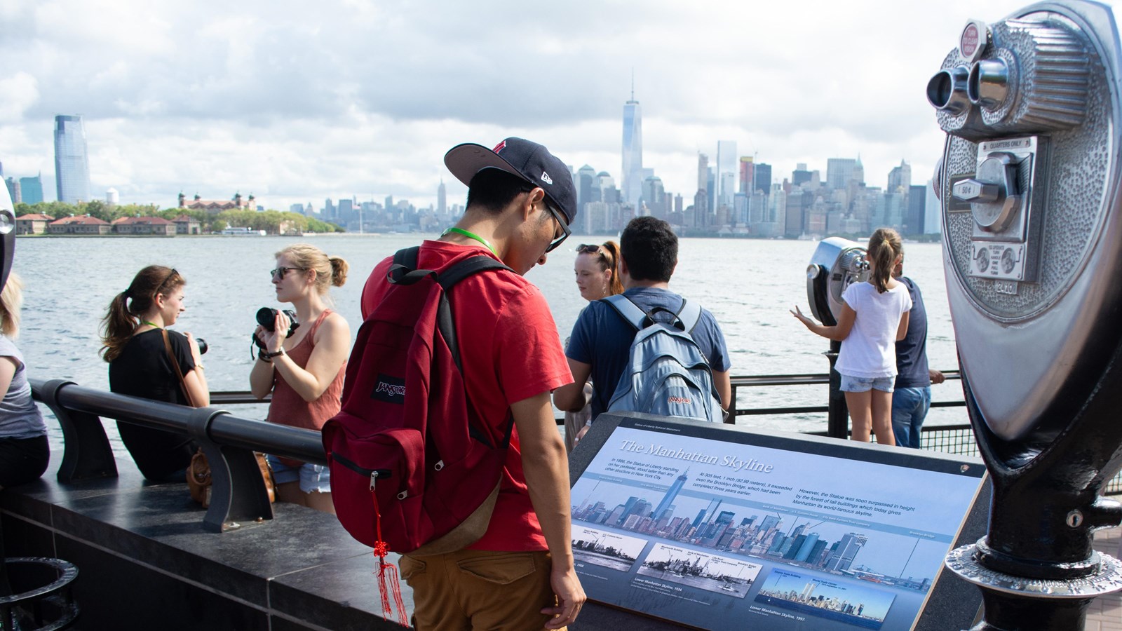 People along railing above water