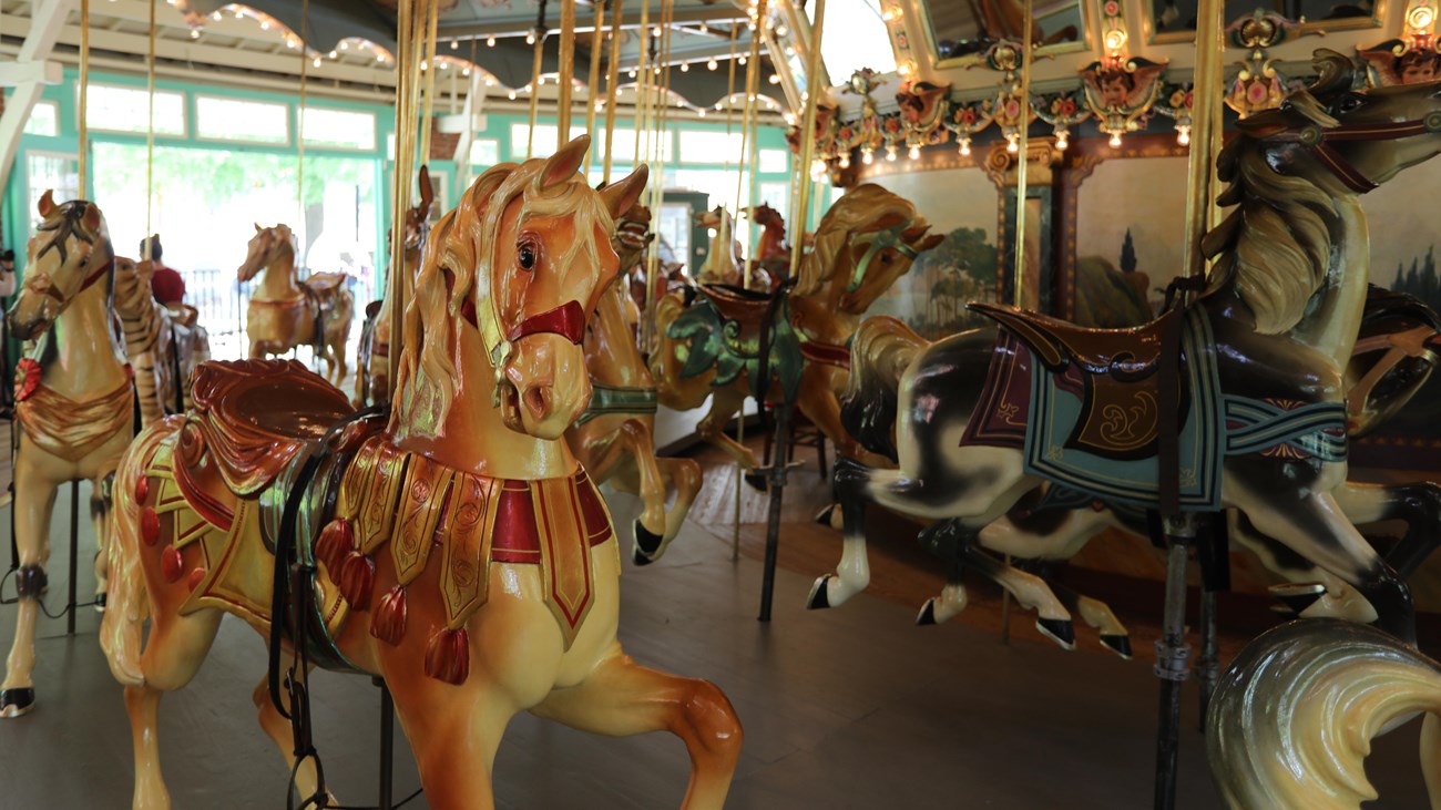 Colorful horses and lights on a carousel.