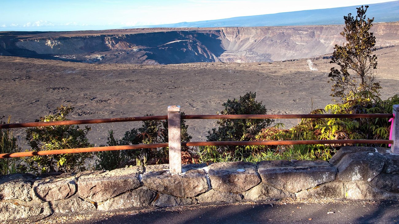 Overlook into a volcanic crater with trees in the foreground