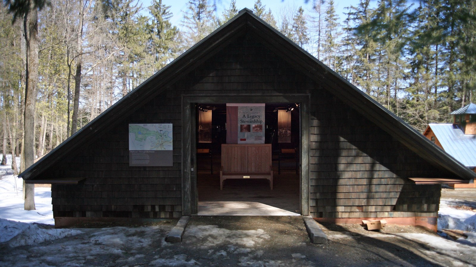 Woodbarn with sliding doors open displaying exhibit with lights