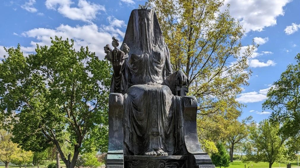 A bronze sculpture of a veiled Egyptian goddess. 