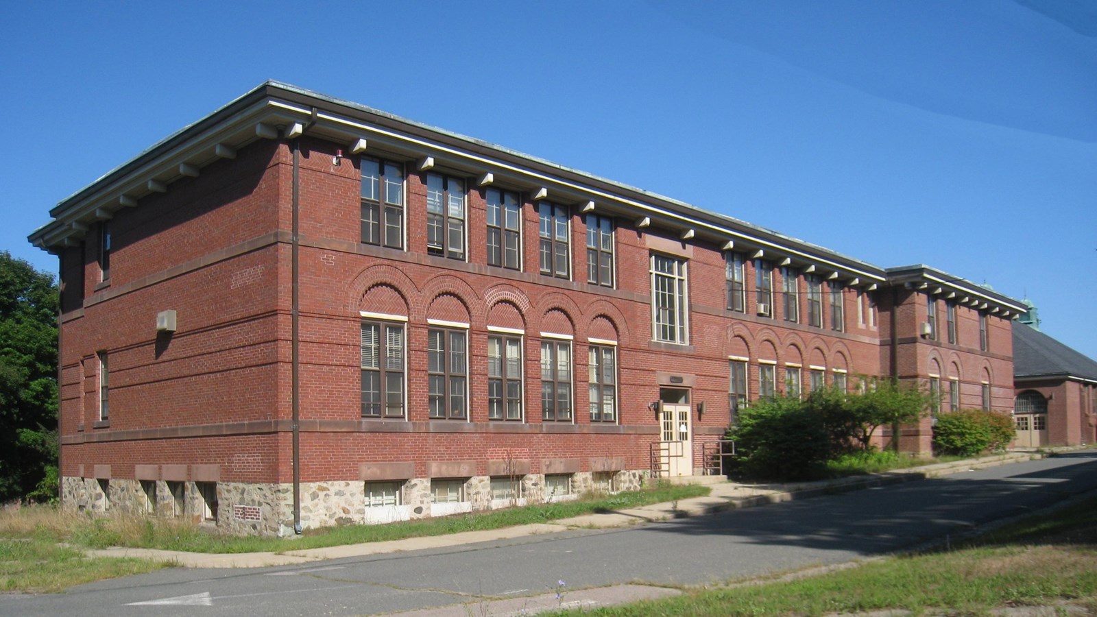 Large, two-story red brick building
