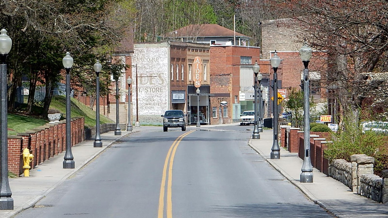 street running through downtown with brick buidlings 